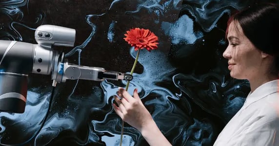 A robotic arm hands a woman a red flower.